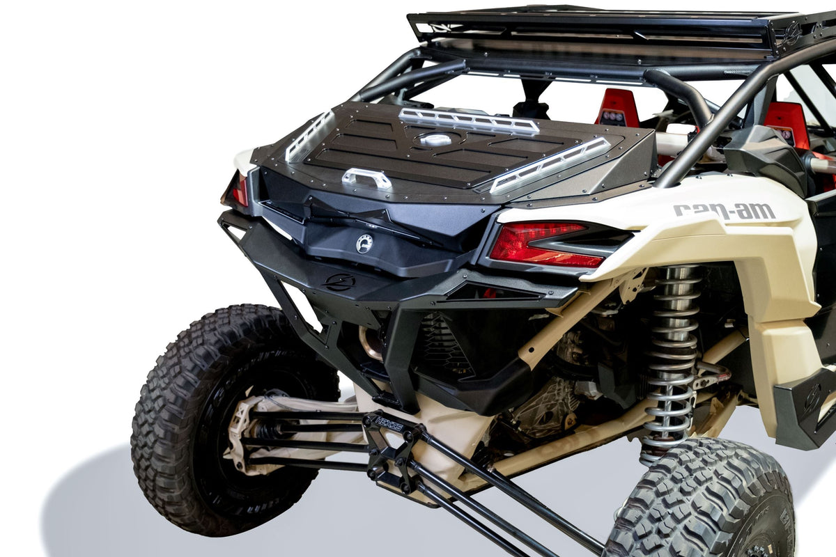 Rear three-quarter view of Can-Am Maverick X3 Baja Bed Box showing dual-latch lid and satin black accent panels