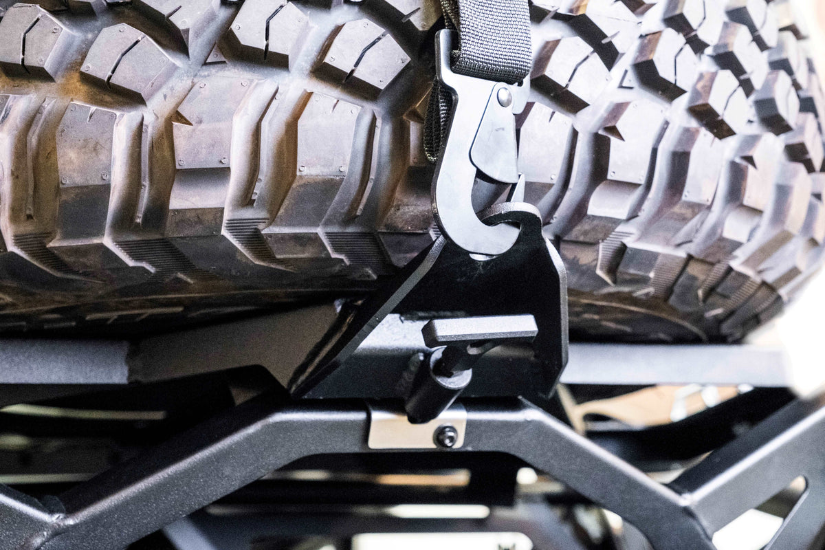 Direct rear view of Can-Am Maverick X3 spare tire carrier showing secure tire mounting