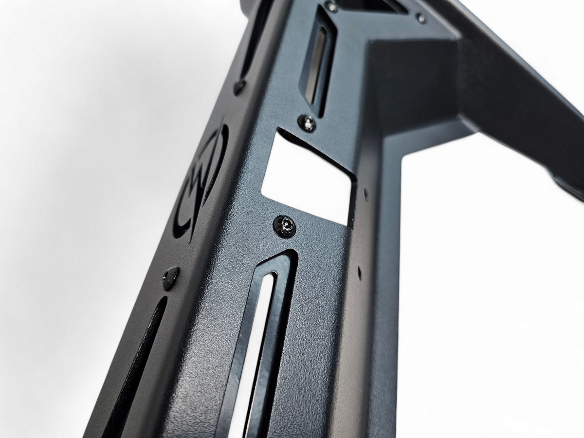 Detail of backup camera relocation slot and mounting hardware on Can-Am Maverick R Rear Volt Bumper showing factory camera fitment provision