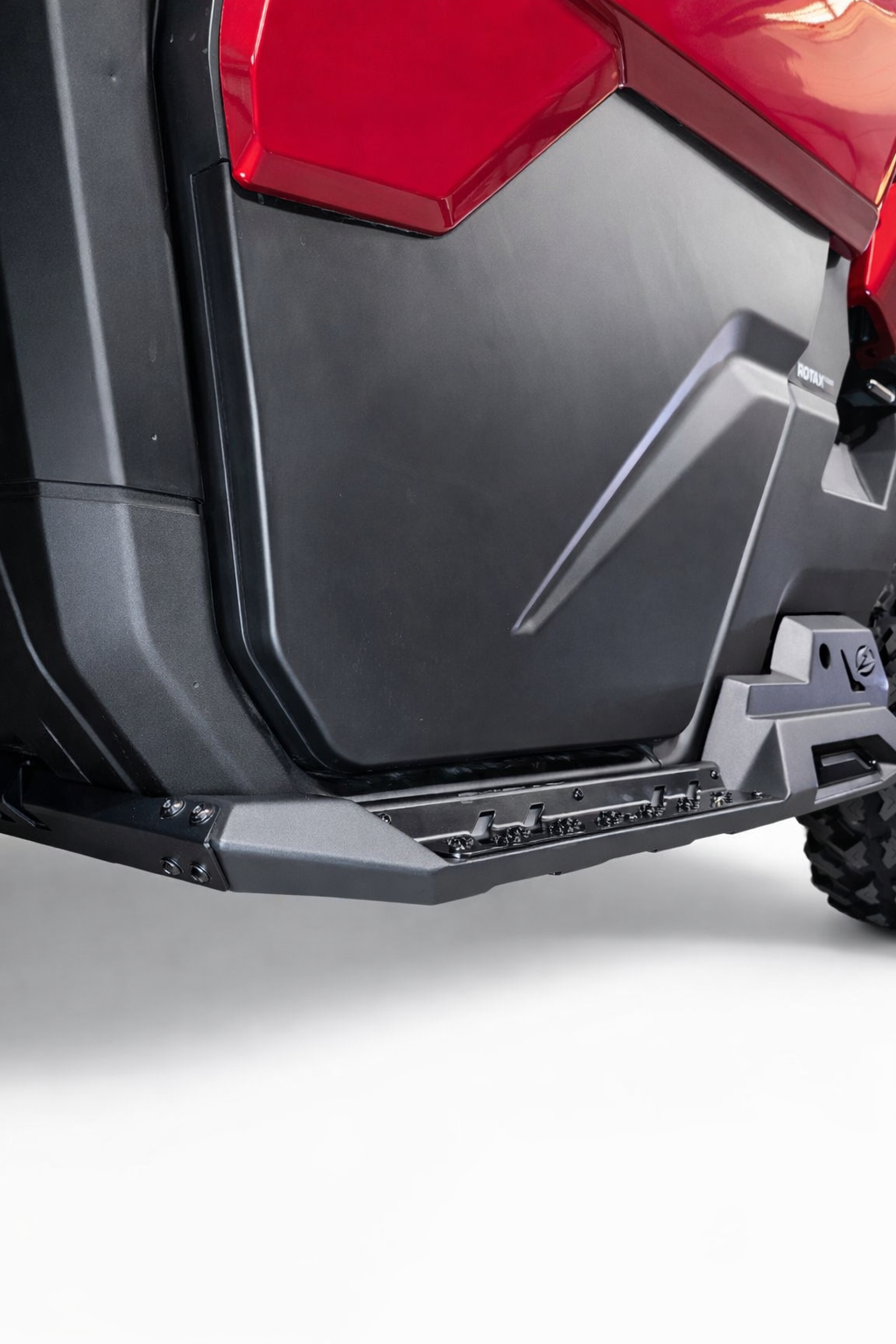 Driver side Volt Rock Steps installed on 2-seat Can-Am Defender showing frame protection