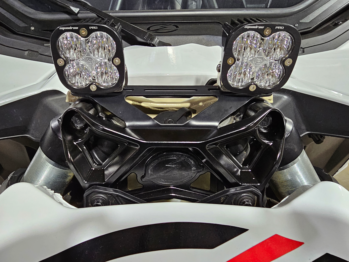Bolt-on installation detail on Can-Am Maverick X3 upper shock mount brace