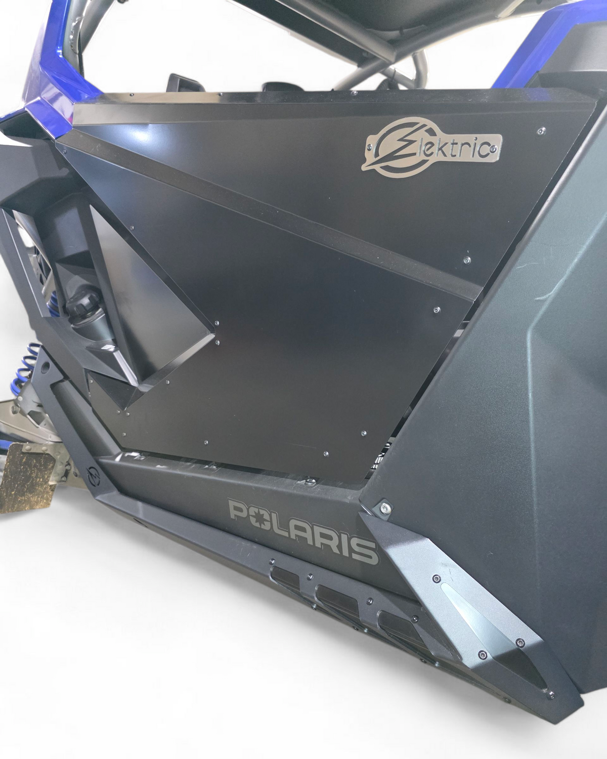 Full side view of 2-seat Polaris RZR with Volt Series rock sliders