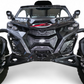 2024 Can-Am Maverick R fitted with Volt 3-Piece Grille in hammer black powder coat
    finish, full front view on a desert trail showing contour-matched fitment and
    billet aluminum badge detail