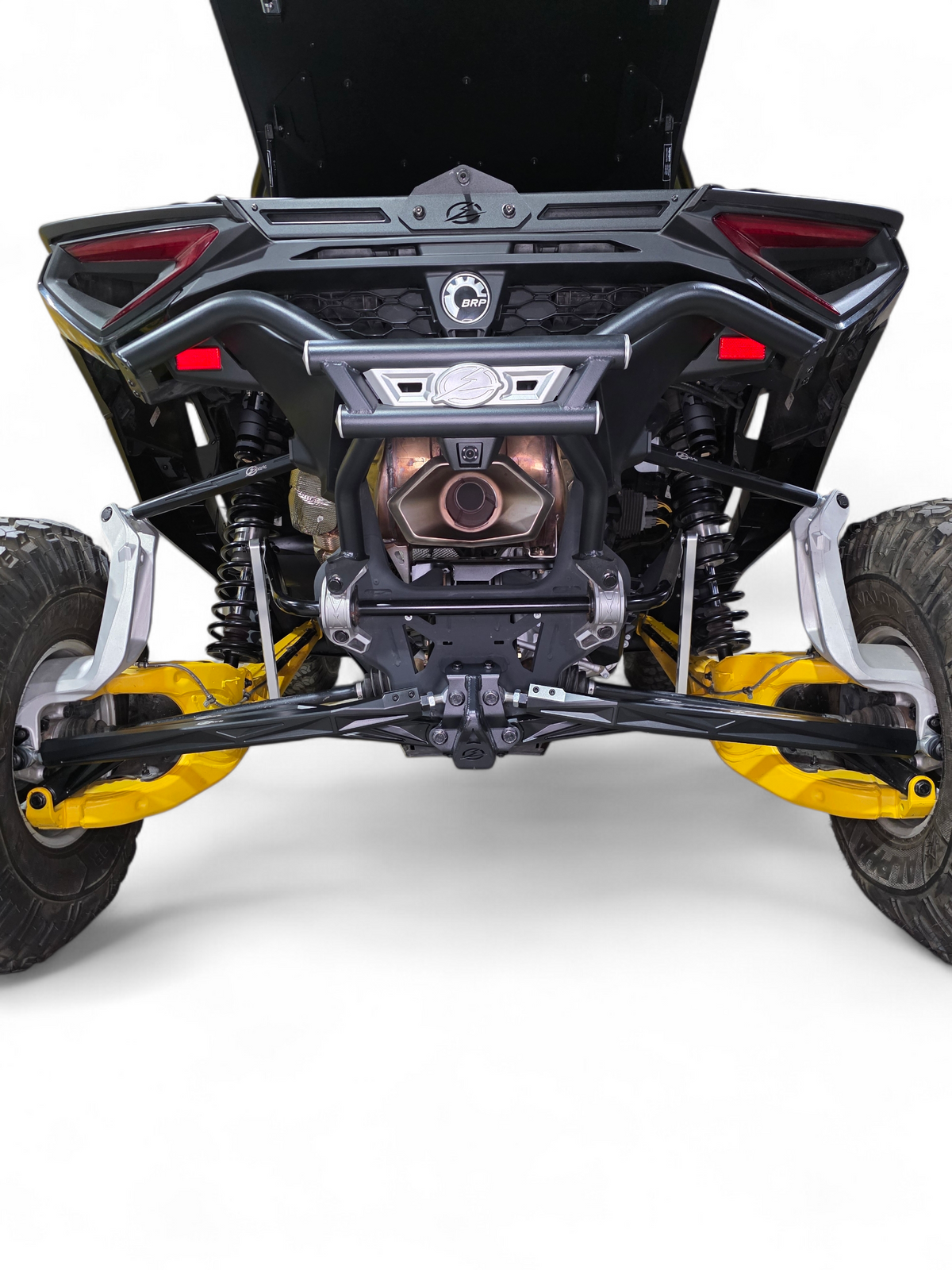 2024 Can-Am Maverick R front suspension fitted with High Clearance Adjustable
    Radius Rods in anodized black finish showing full installation and high clearance