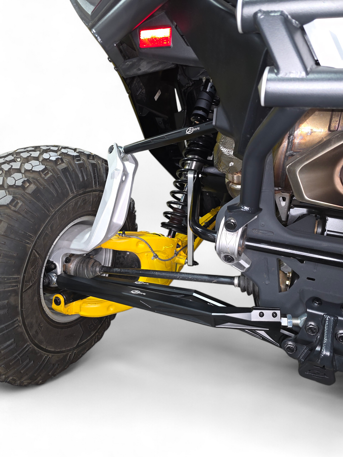 2024 Can-Am Maverick R rear suspension fitted with High Clearance Adjustable
    Radius Rods in anodized black finish showing full installation