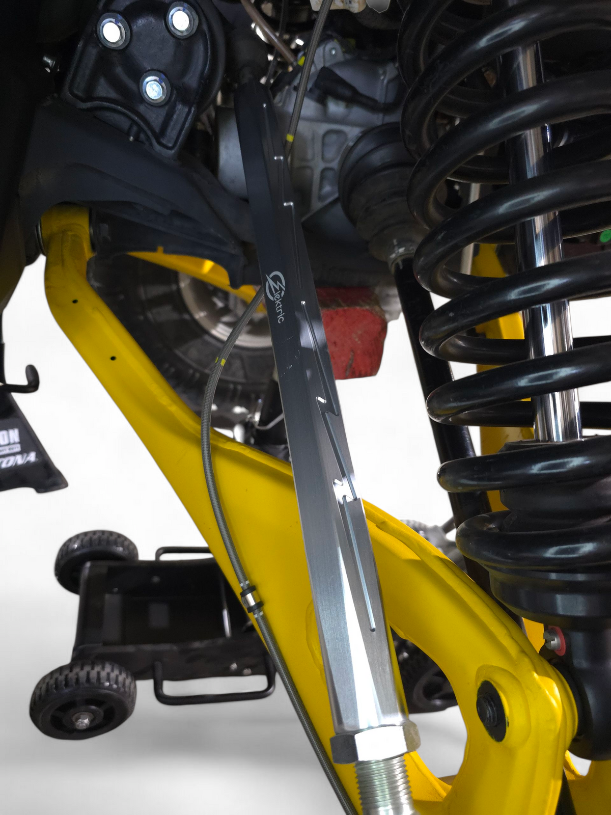 Clear anodized Maverick R tie rod connected to the factory rod end