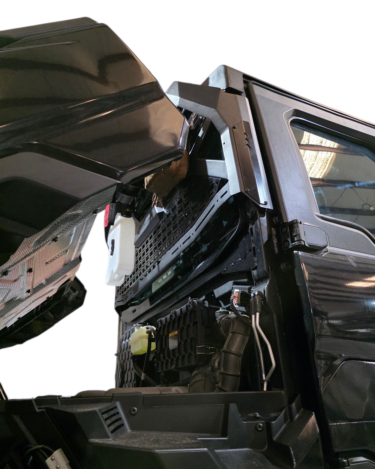 Cover plate detail concealing factory cargo light location on Polaris Ranger 1500 Headache Rack