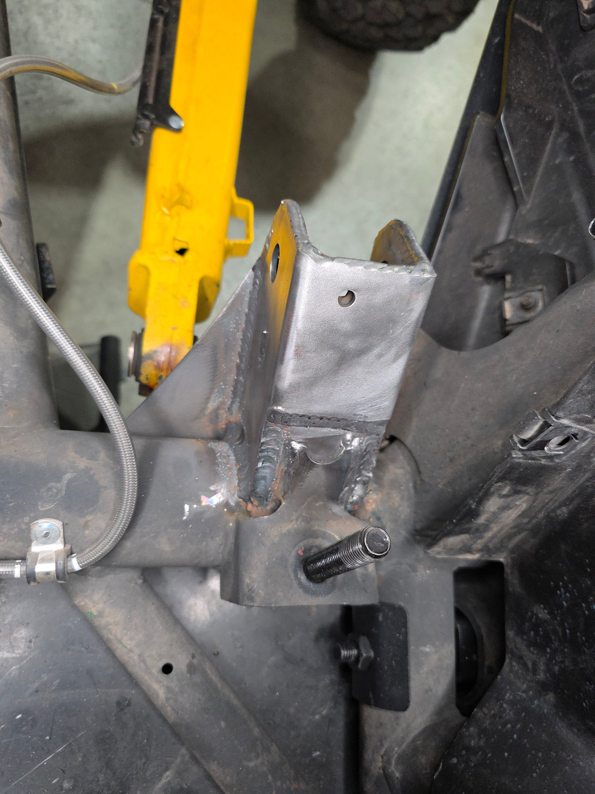 Trailing arm pivot gusset welded to Can-Am Maverick R chassis showing finished reinforcement