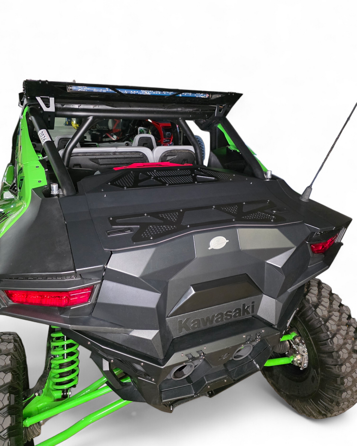 Green and black Kawasaki off-road vehicle on a white background