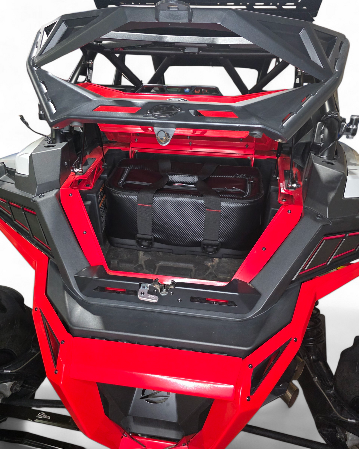 Polaris RZR Baja bed box with lid open on gas struts showing interior storage
