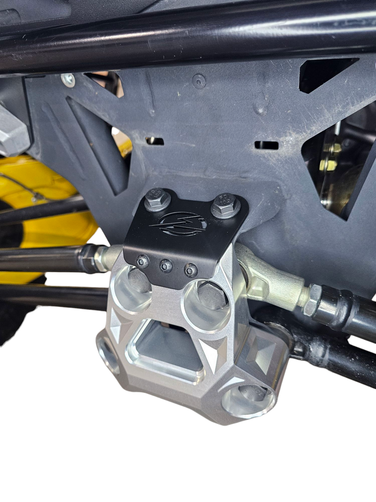 Side view of clear anodized Can-Am Maverick R billet radius rod plate installed