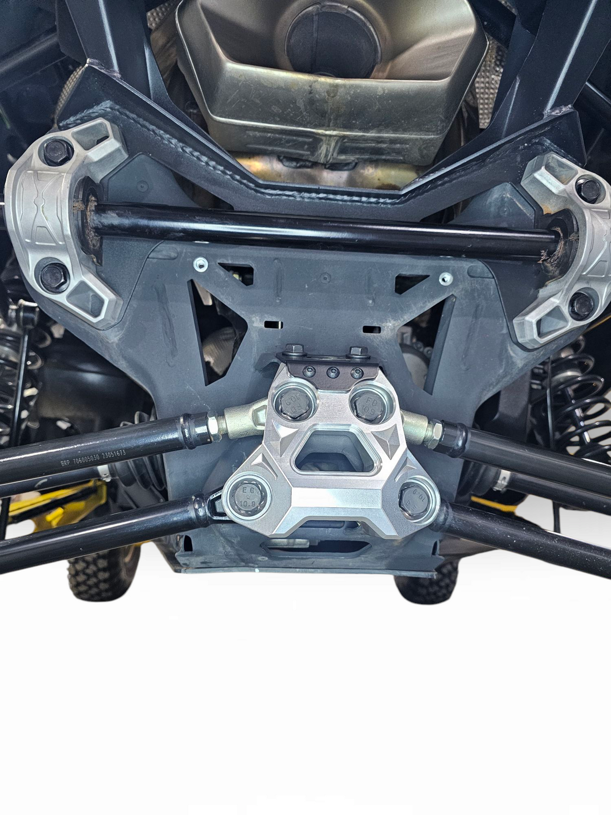 Close-up of CNC machining visible through clear anodize on Can-Am Maverick R radius rod plate