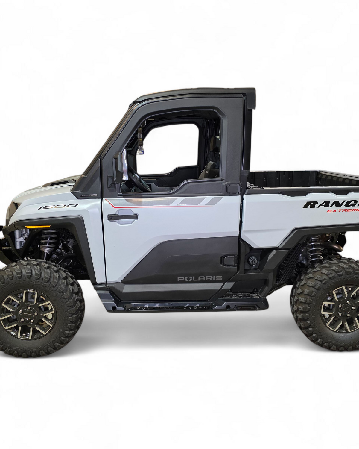 Side profile of 2-seat Polaris Ranger XD 1500 with rock sliders installed