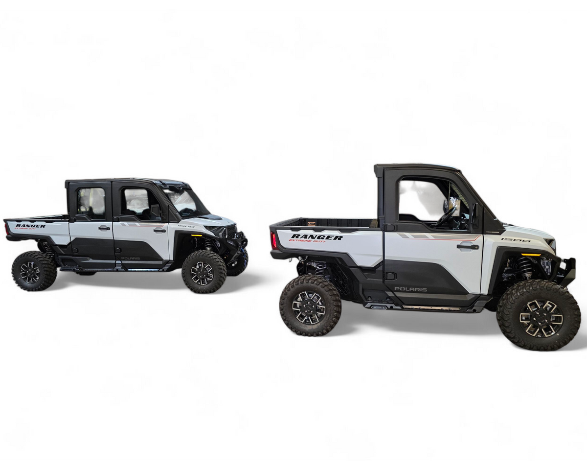 Full side view of 2-seat Polaris Ranger XD 1500 with rock sliders protecting the lower body