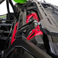 Close-up of a red and black mechanical component on a vehicle, likely a UTV or ATV.