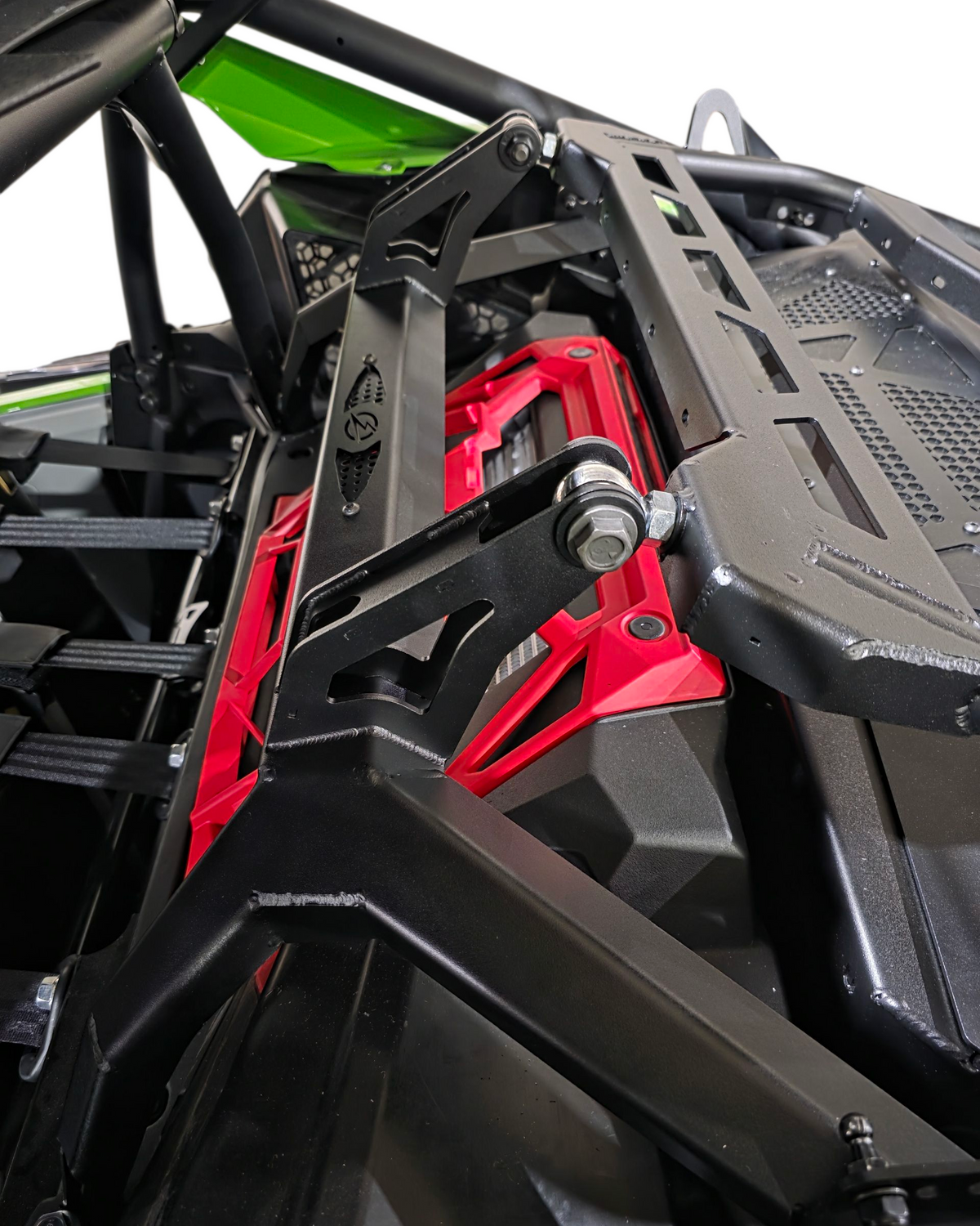 Close-up of a red and black mechanical component on a vehicle, likely a UTV or ATV.