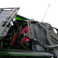 Close-up of a green vehicle's interior with black and red components on a white background