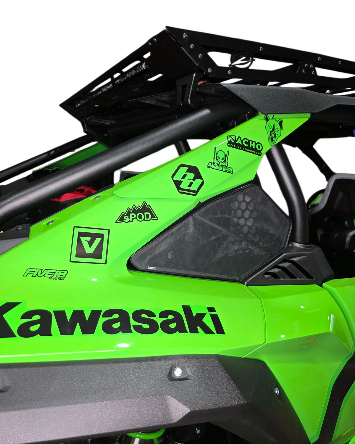 Close-up of a green Kawasaki vehicle with various decals on a white background