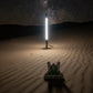 360 camera mount glowing white in the sand
