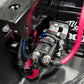 UTV Stereo relay mounted near a 12V battery with red power cables connected