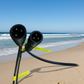 Two black electrical plugs with a cable on a desert background