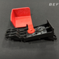 Black plastic automotive bracket with attached red protective cover