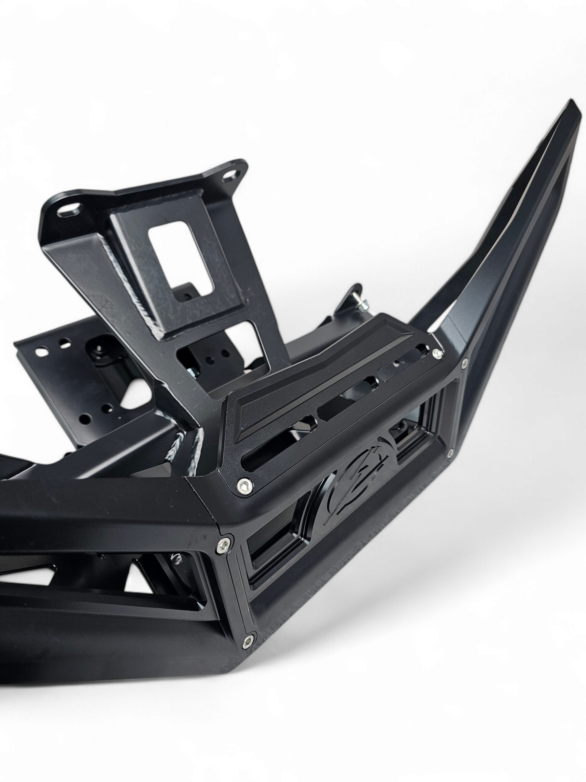 Direct front view of black anodized Can-Am Maverick X3 billet front winch bumper showing built-in fairlead slot and symmetrical design