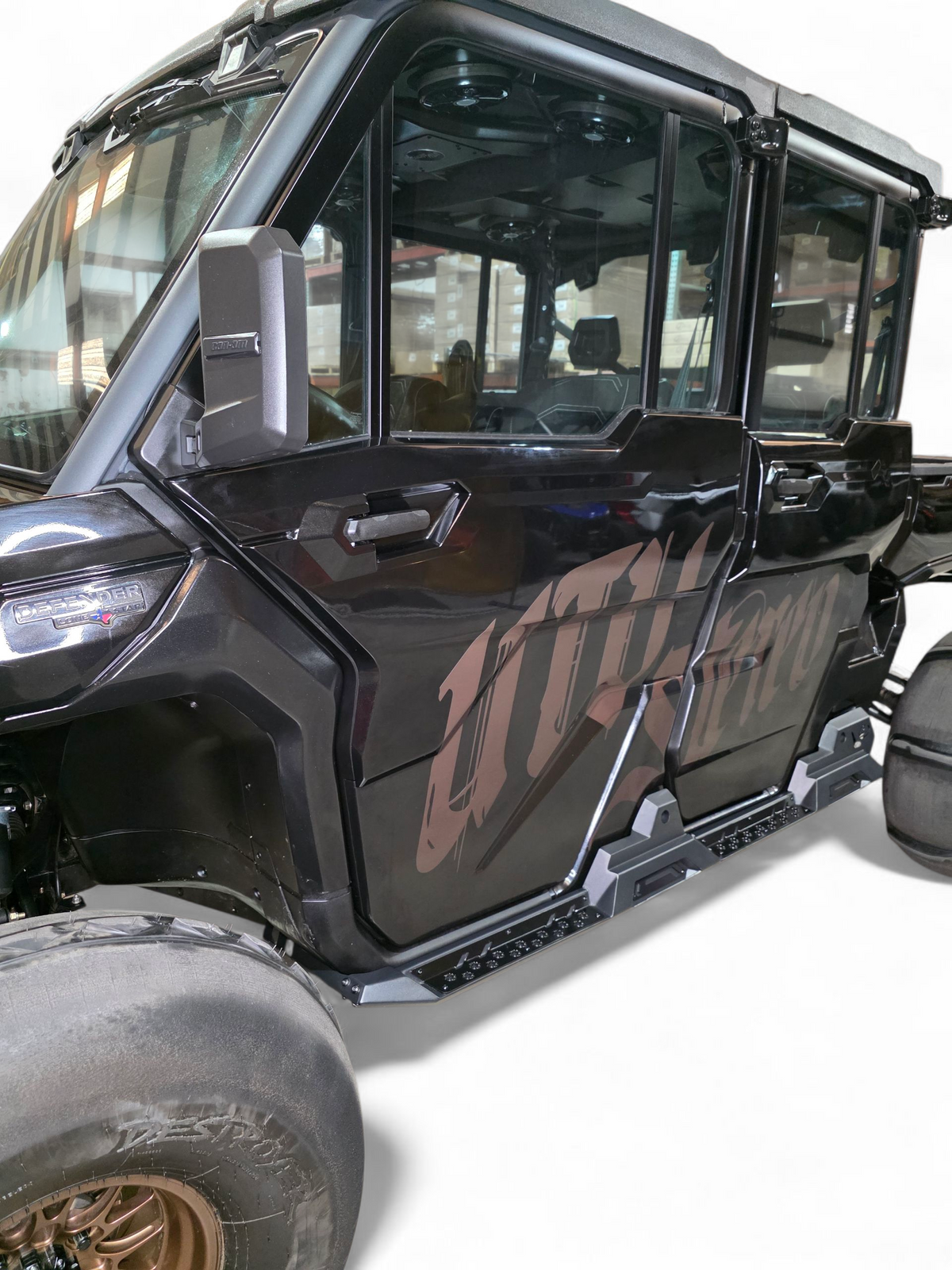 Volt Rock Steps installed on 4-seat Can-Am Defender HD10 showing steel side protection and built-in step