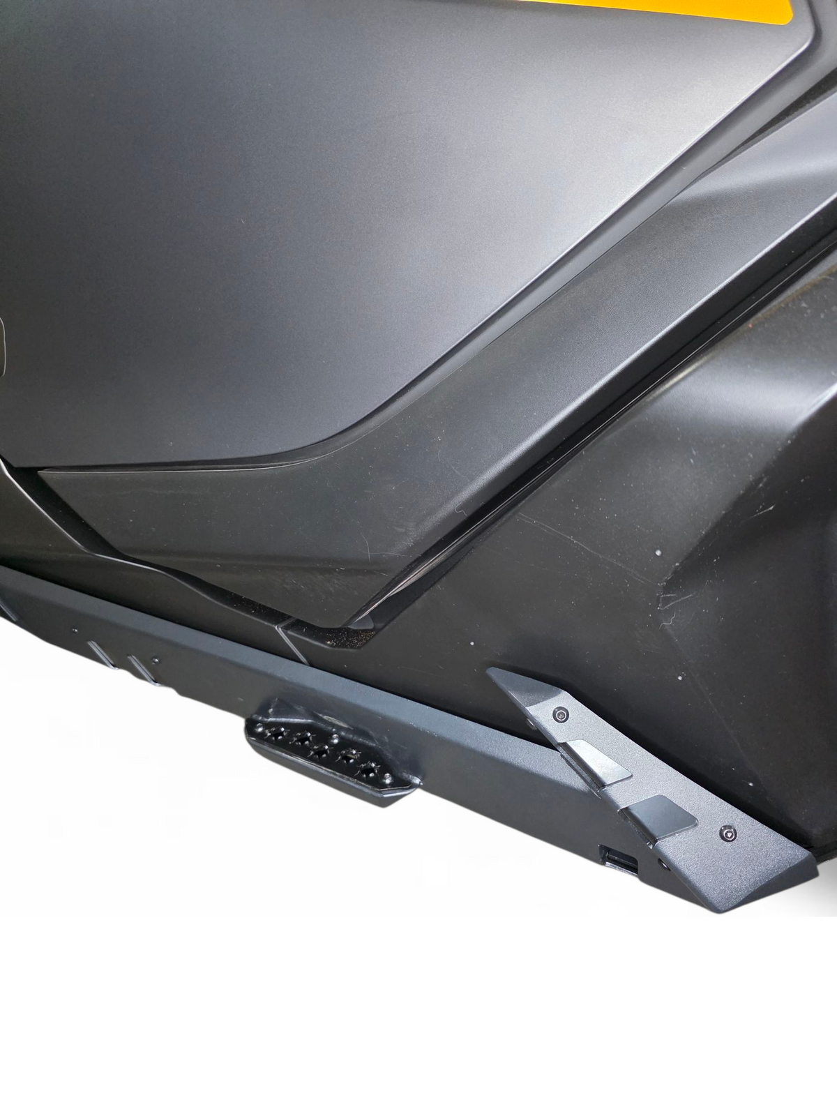 Full machine side view of 2-seat Can-Am Maverick R fitted with Volt Rocker Steps