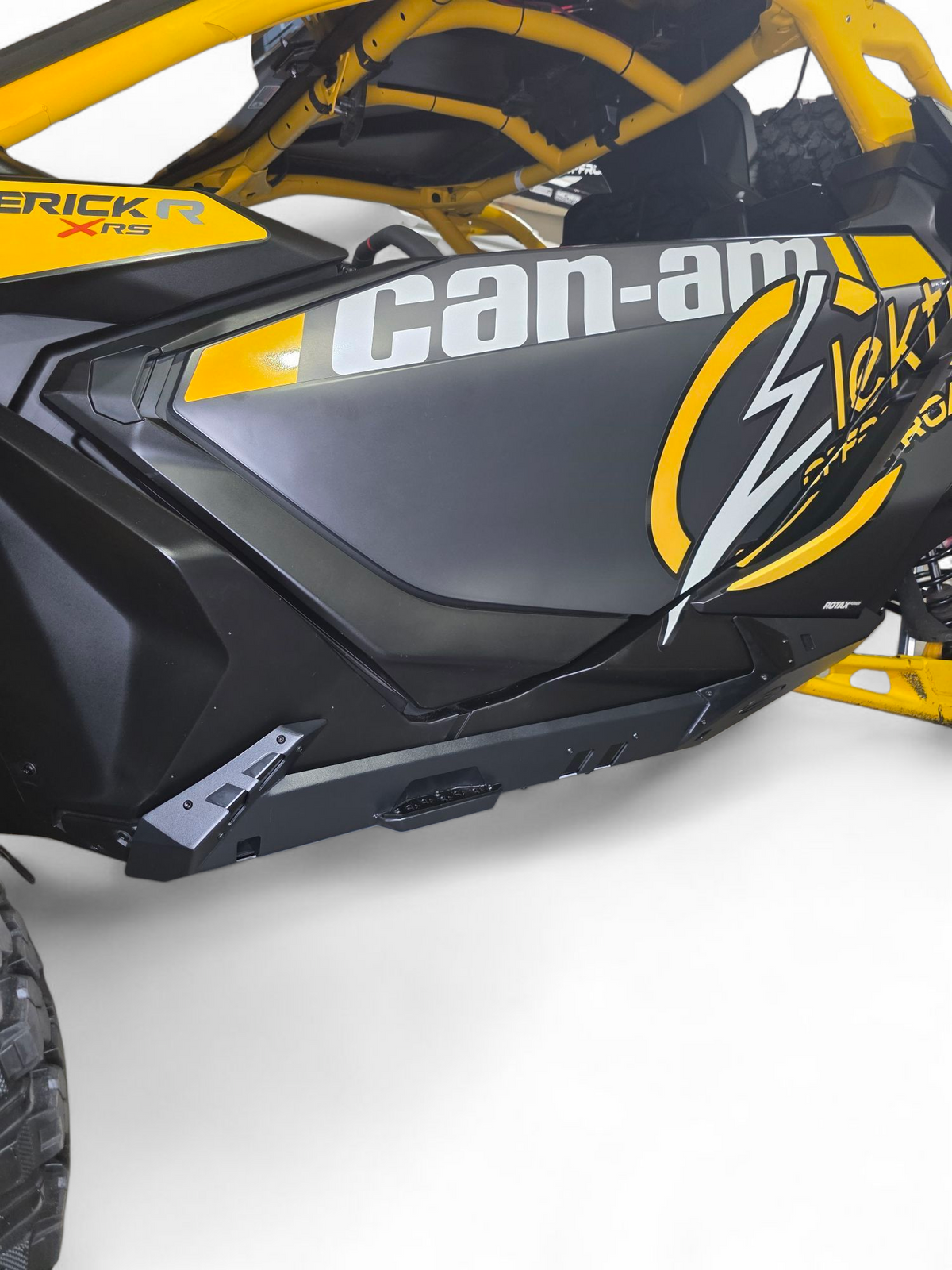 Passenger side Volt Rocker Steps on 2-seat Can-Am Maverick R showing rock slider integration