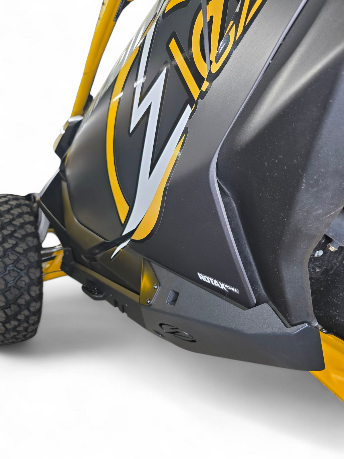 Bolt-on mounting point detail on Can-Am Maverick R Volt Rocker Steps showing factory frame attachment