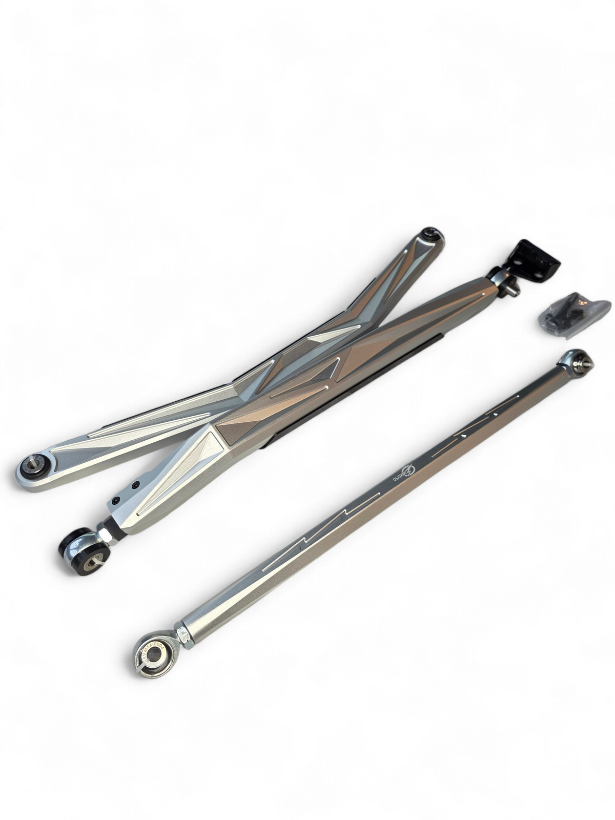 2024+ Can-Am Maverick R anodized clear radius rods installed on rear suspension showing high clearance profile and Heim joint detail