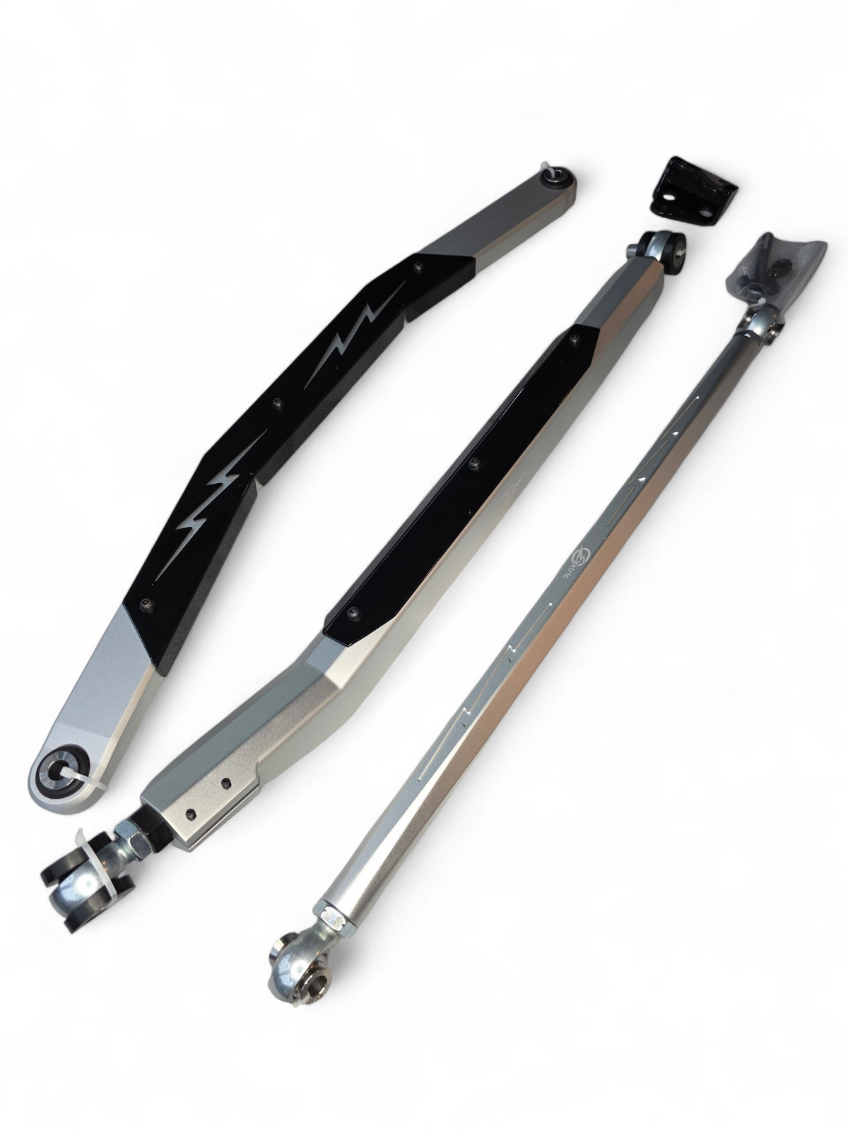 Removable brush shield installed on Can-Am Maverick R High Clearance Radius Rod protecting Heim joints from trail debris