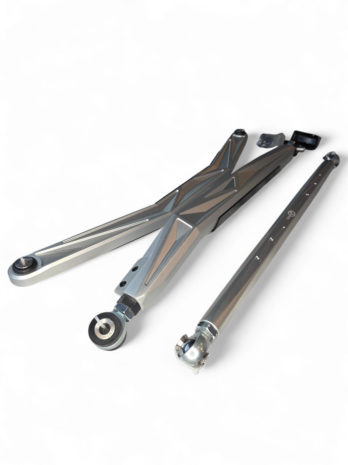 Can-Am Maverick R High Clearance Radius Rods laid flat showing full set, removable brush shields, and included hardware kit