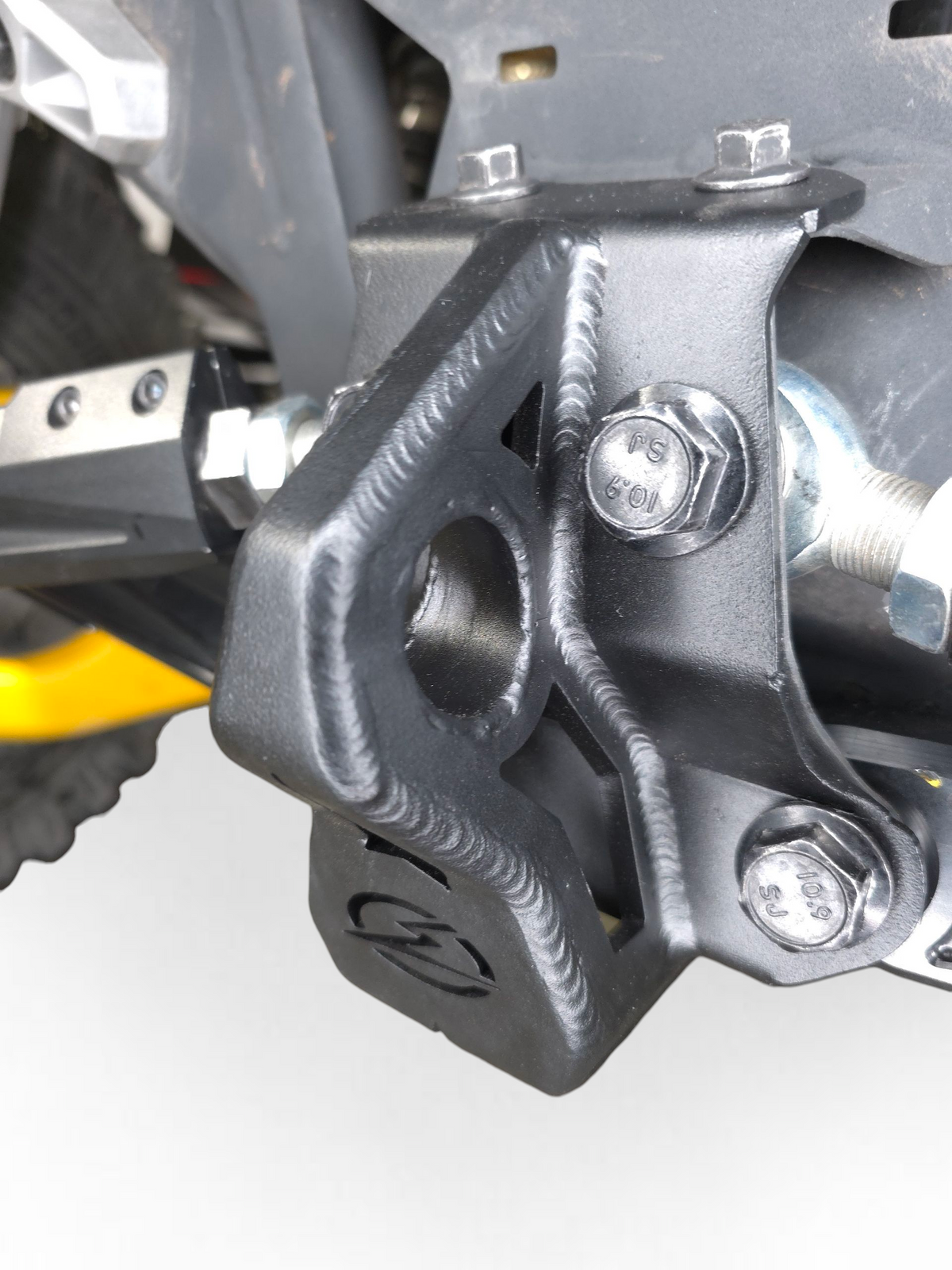 Rear suspension reinforcement detail on Can-Am Maverick R steel radius rod plate