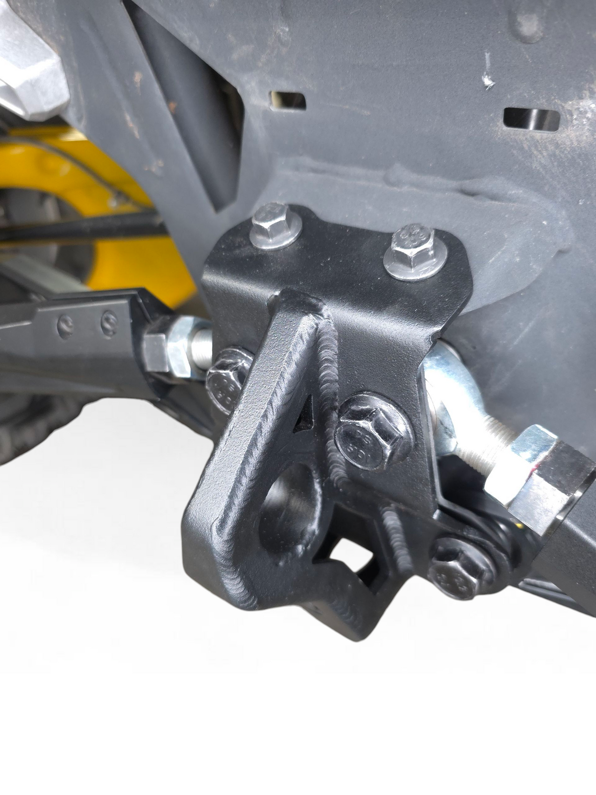 Bolt-on mounting points on Can-Am Maverick R sheet metal radius rod plate showing installation