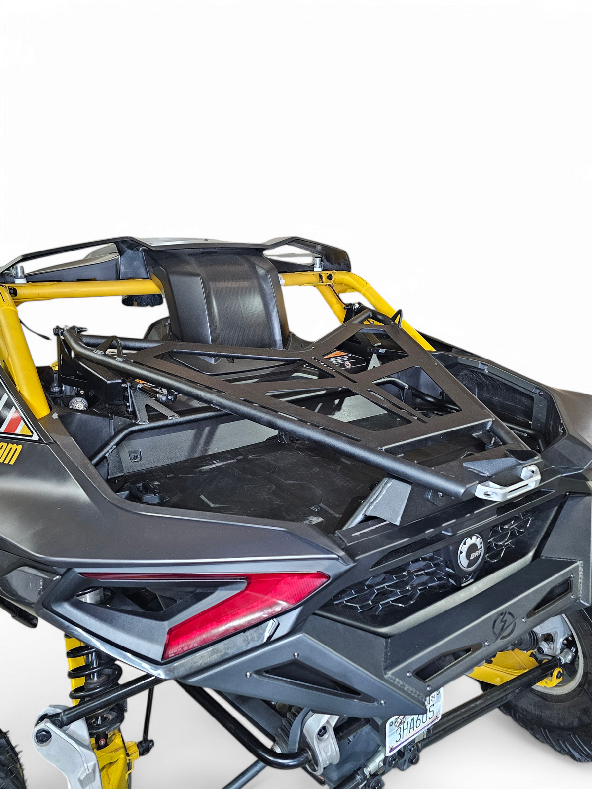 Driver side view of Can-Am Maverick R fitted with EOD Volt Tire Rack showing complete mounting profile and body integration