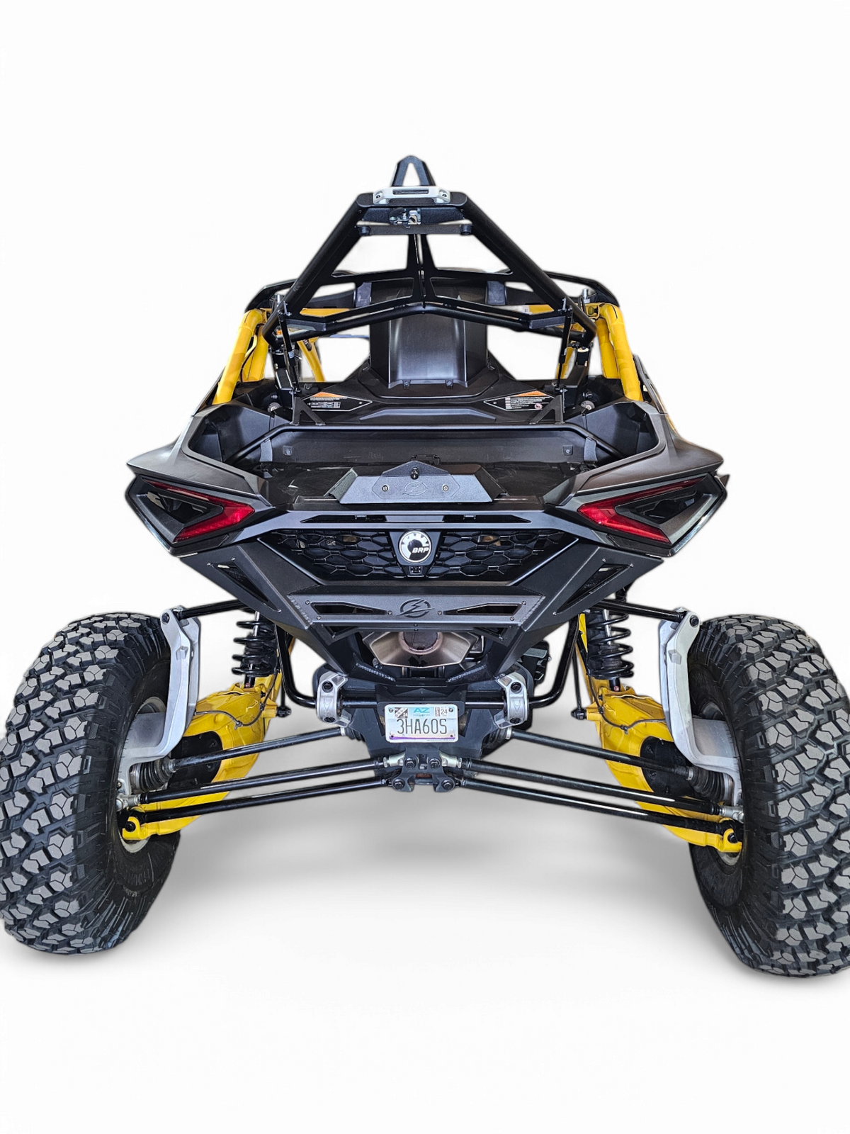 EOD Volt Tire Rack bolt-on mounting points on Can-Am Maverick R showing factory integration and upper shock mount reinforcement
