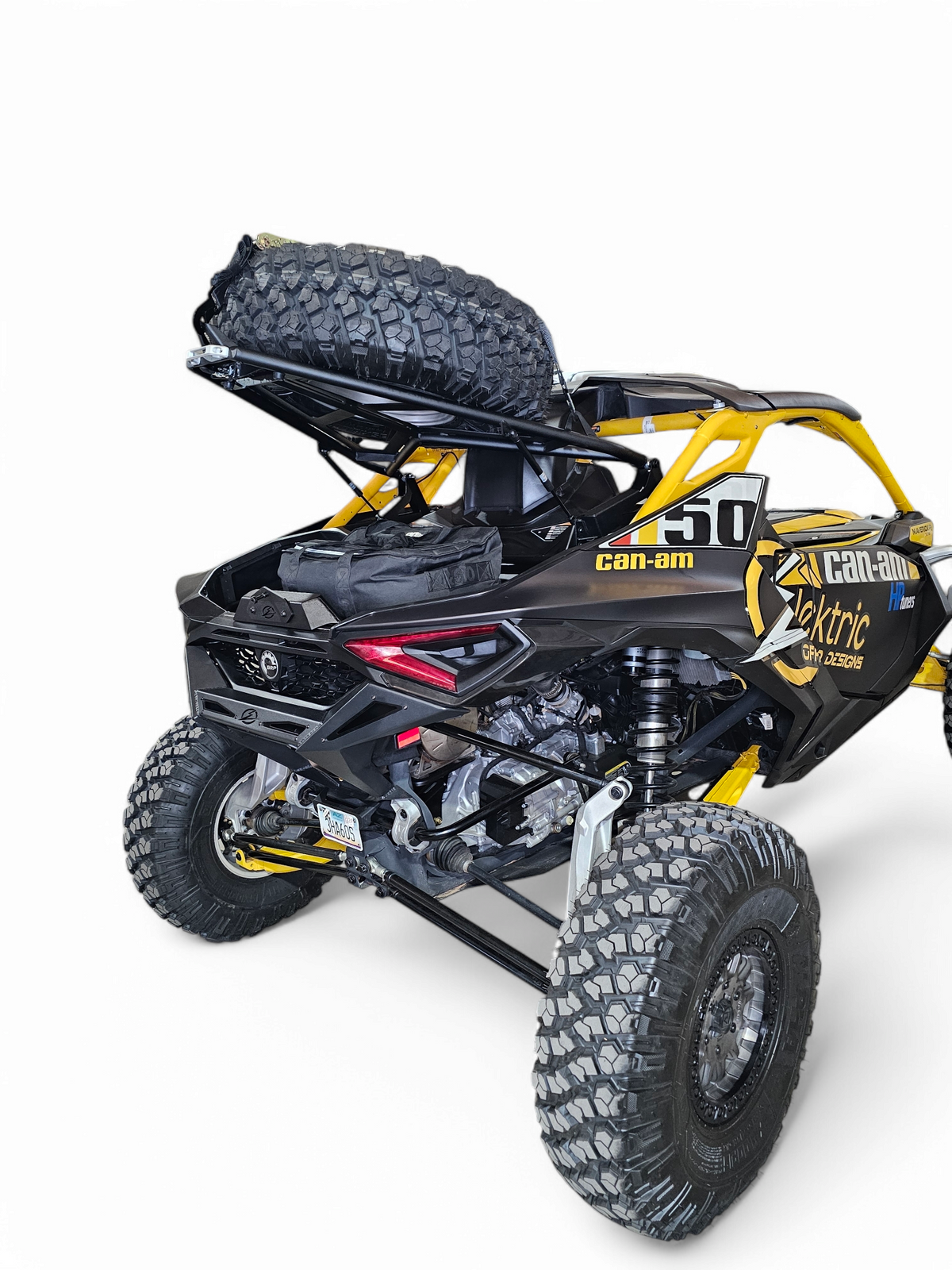 Can-Am Maverick R fitted with EOD Volt Tire Rack showing rear three-quarter angle with 35-inch spare tire mounted securely