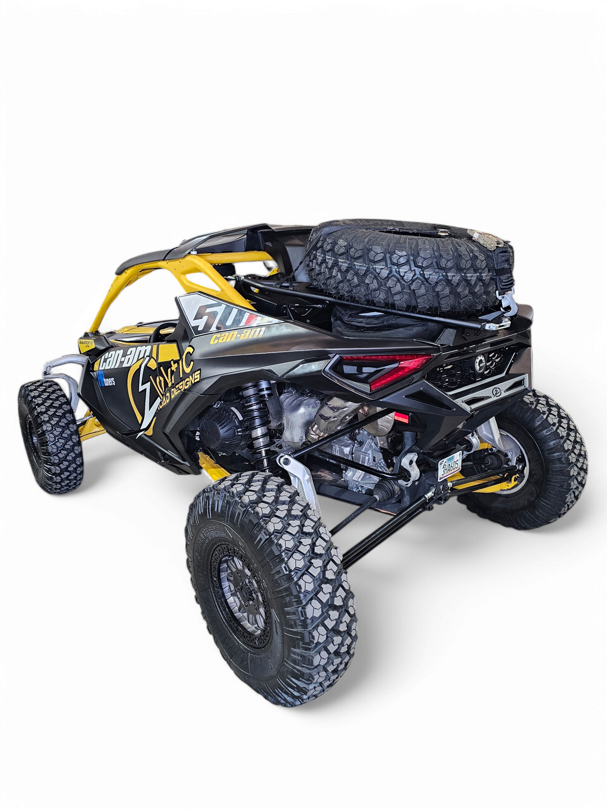 Side angle of Can-Am Maverick R with EOD Volt Tire Rack installed showing integration with vehicle body lines and tire clearance