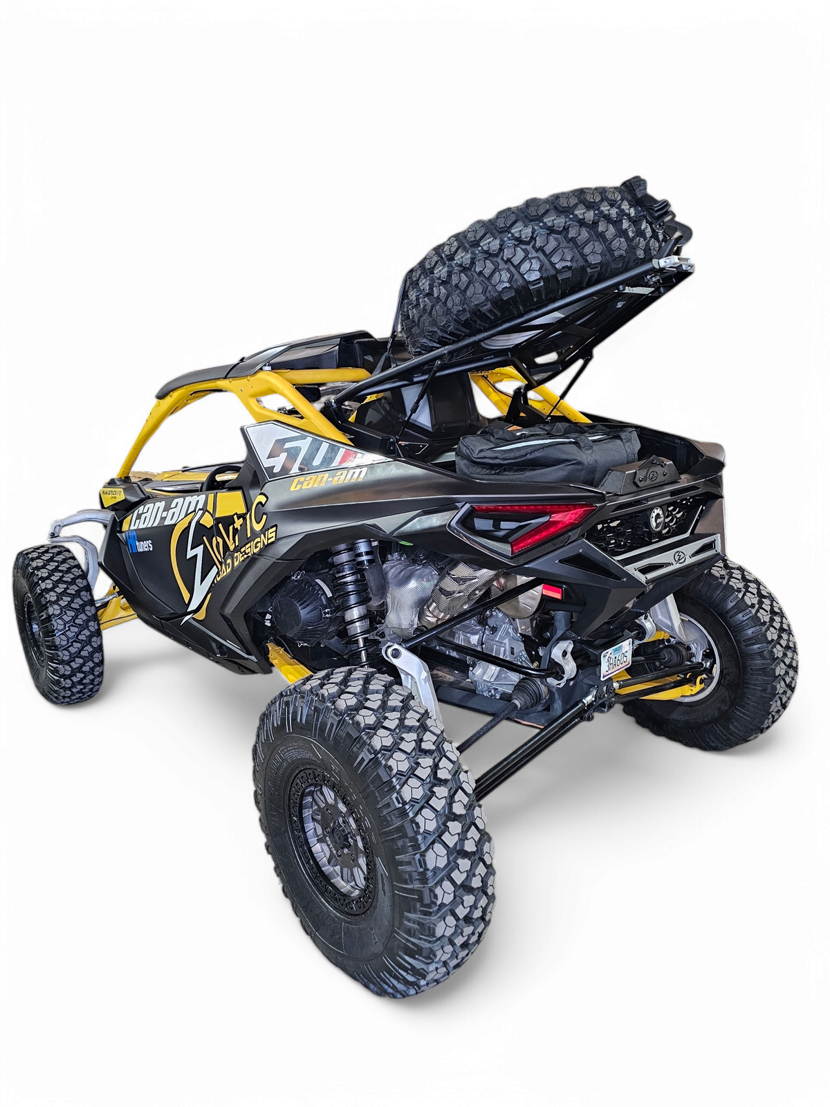 Can-Am Maverick R EOD Volt Tire Rack showing dual gas struts holding lid open hands-free demonstrating opening assistance mechanism