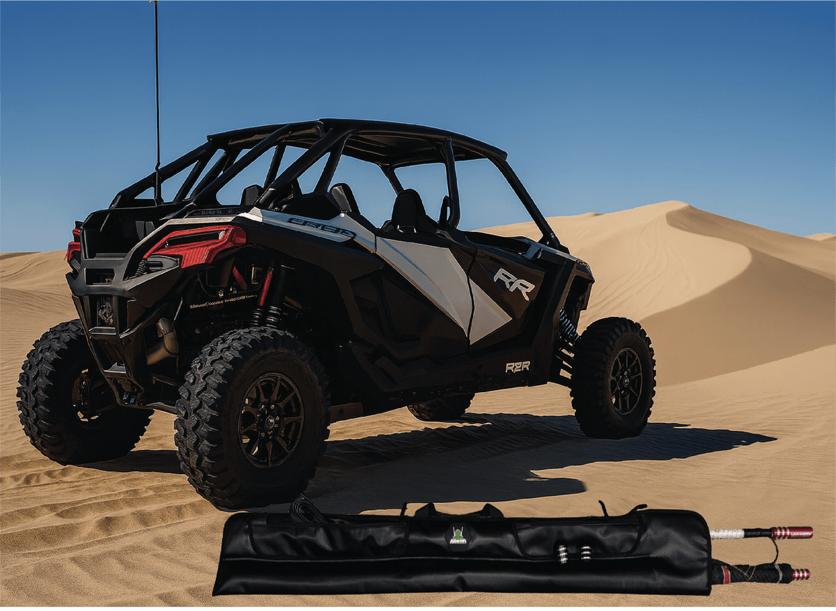 Off-road vehicle on sand dunes with a folded canopy in the foreground