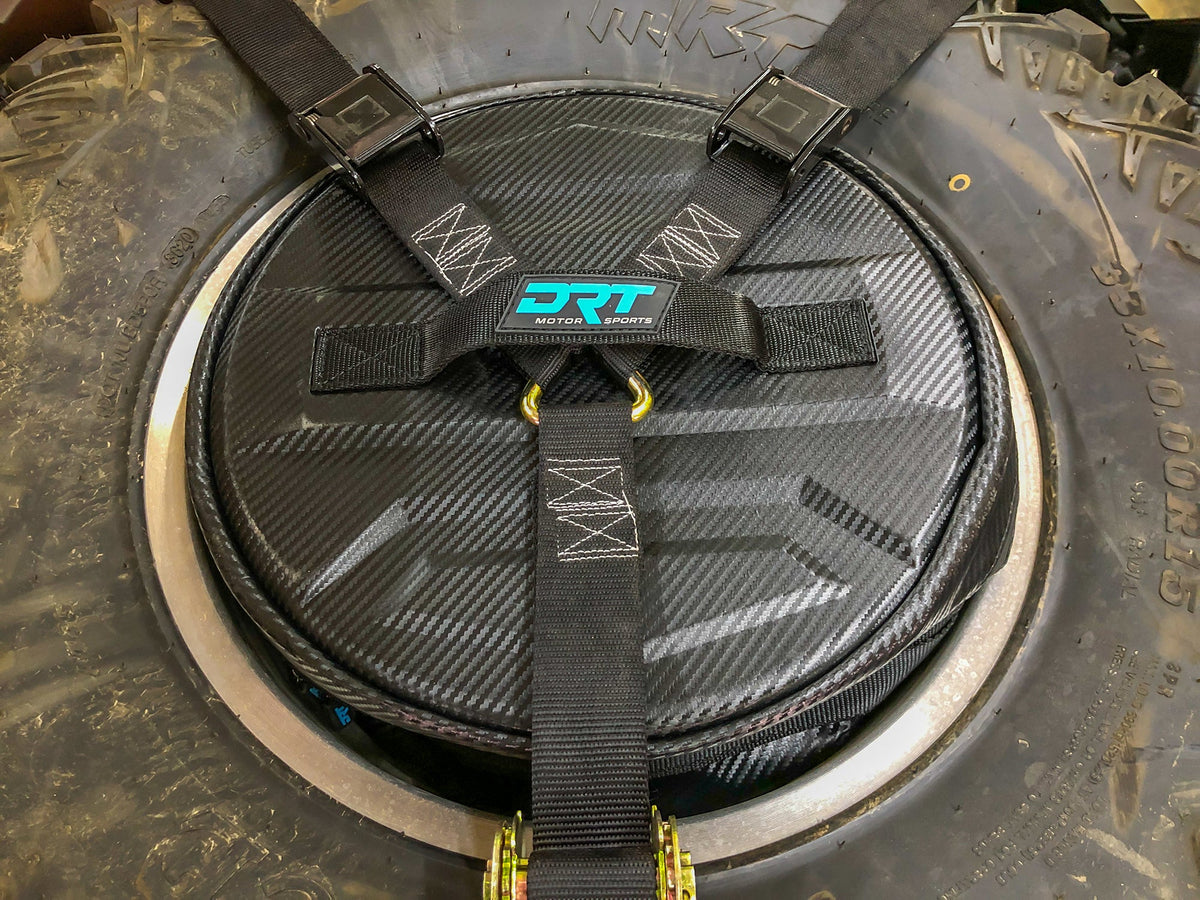 Spare tire storage bag sitting inside inverted off road wheel
