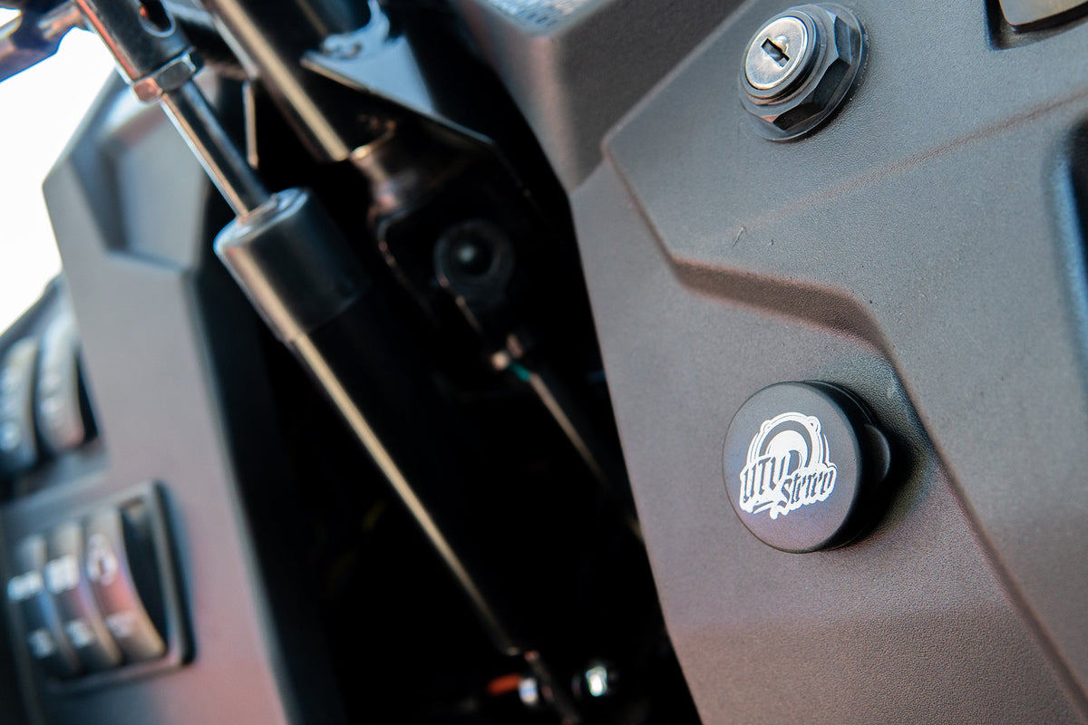UTV Stereo logo emblem mounted on a vehicle dashboard