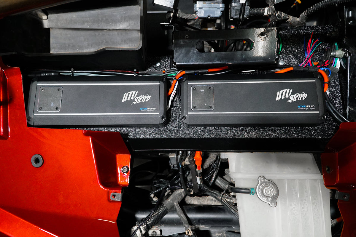 Two UTV Stereo amplifiers mounted in a vehicle engine bay