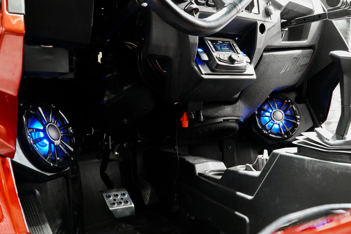 UTV Stereo audio system installed in vehicle dashboard with illuminated blue speakers