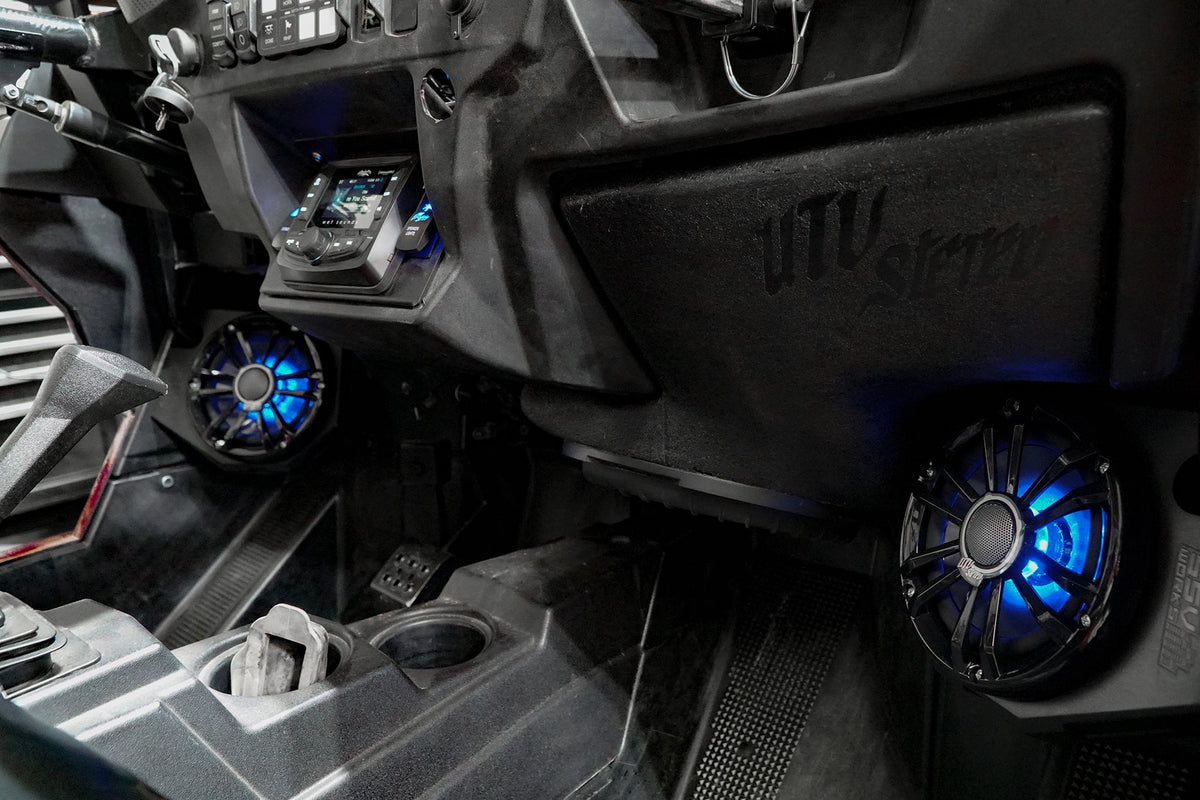 UTV Stereo audio system installed in vehicle dashboard with blue illuminated speakers