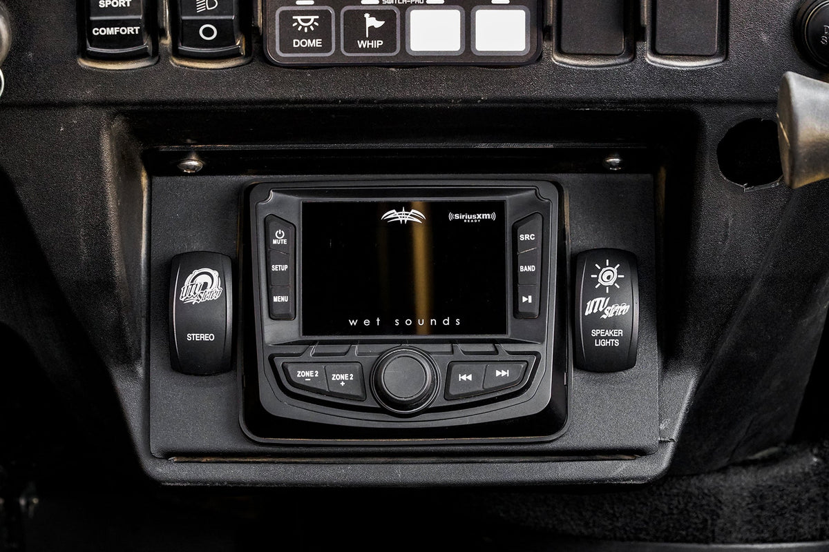 Wet Sounds digital media receiver mounted in a UTV dashboard with UTV Stereo rocker switches