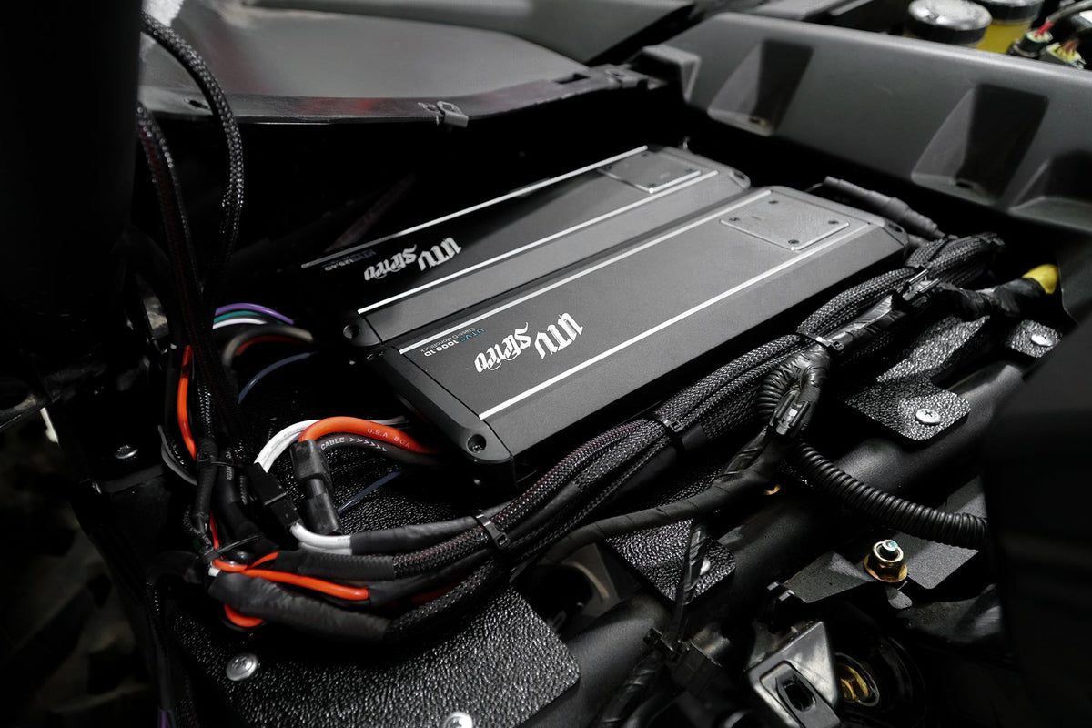 Two UTV Stereo amplifiers mounted with wiring in a vehicle