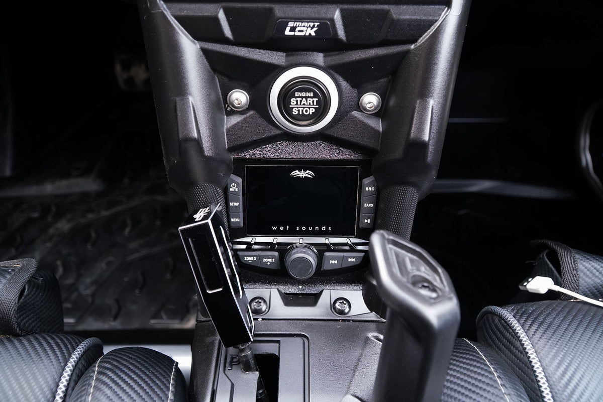 Wet Sounds audio receiver installed in a vehicle center console with Smart Lok and engine start stop button